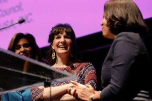 Maile accepts the award for ENGLISH @ WORK at the Women in the World Conference